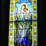 The Virgin Mary holding the Christ Child Sanctuary Window. All three Sanctuary Windows are Tiffany windows given in memory of Dr. Edson (first rector of St. Anne's), his wife Rebecca, and his daughter, Elizabeth. They were installed in 1909, replacing the original McPhersons which had been given in memory of Dr. Edson alone.